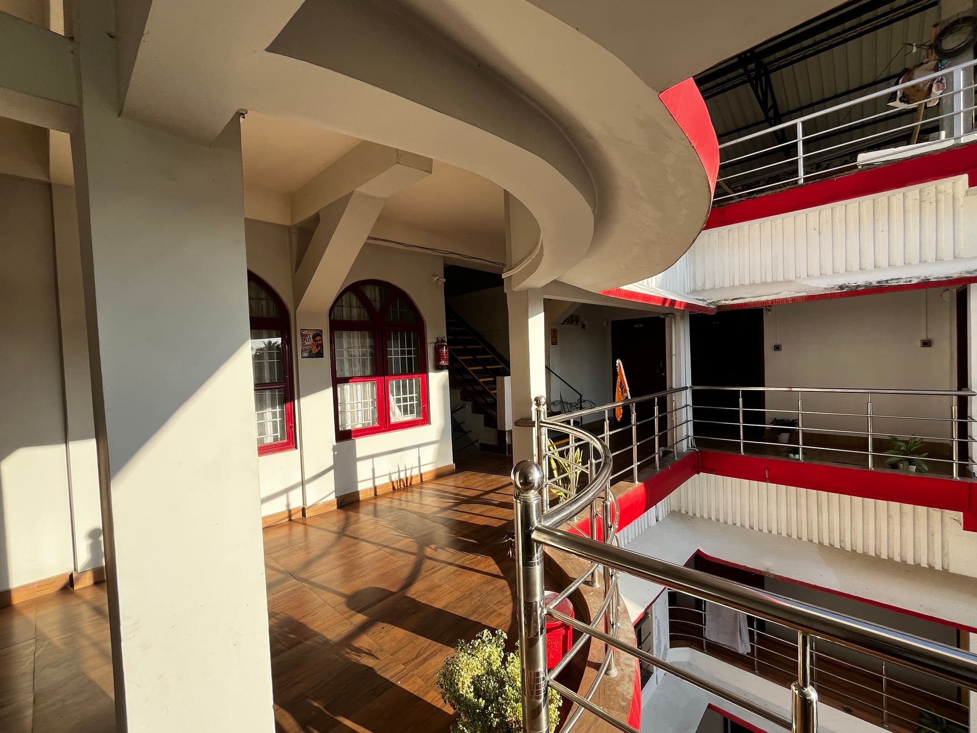 Wooden-floored balcony walkway wrapping around the inner atrium