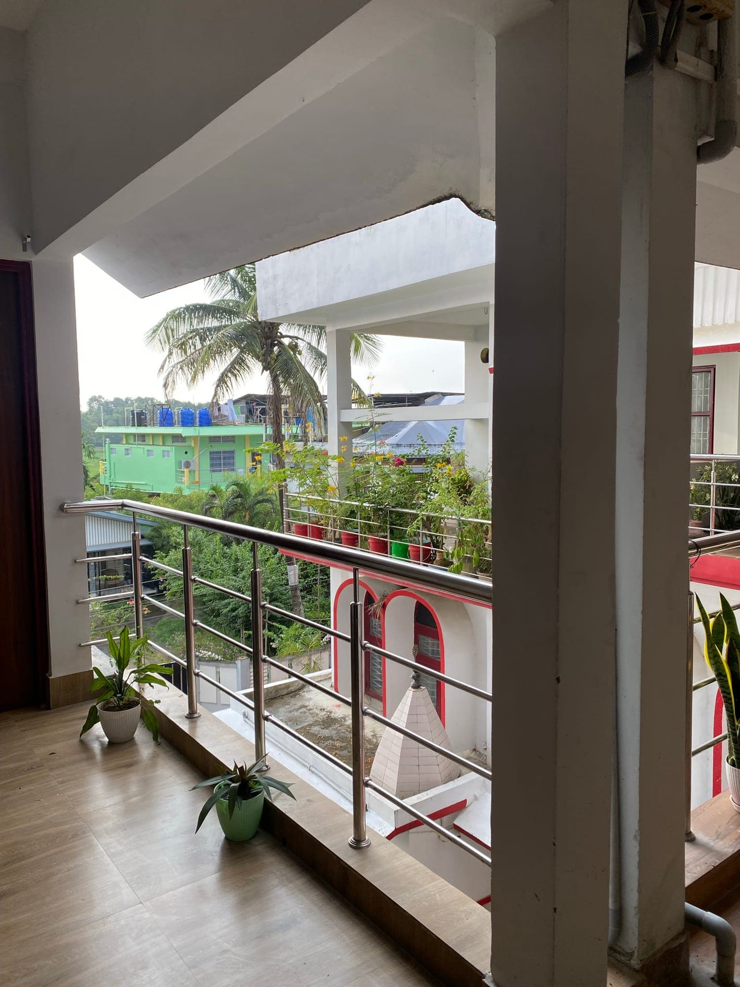 Balcony view of palm trees and the garden terrace